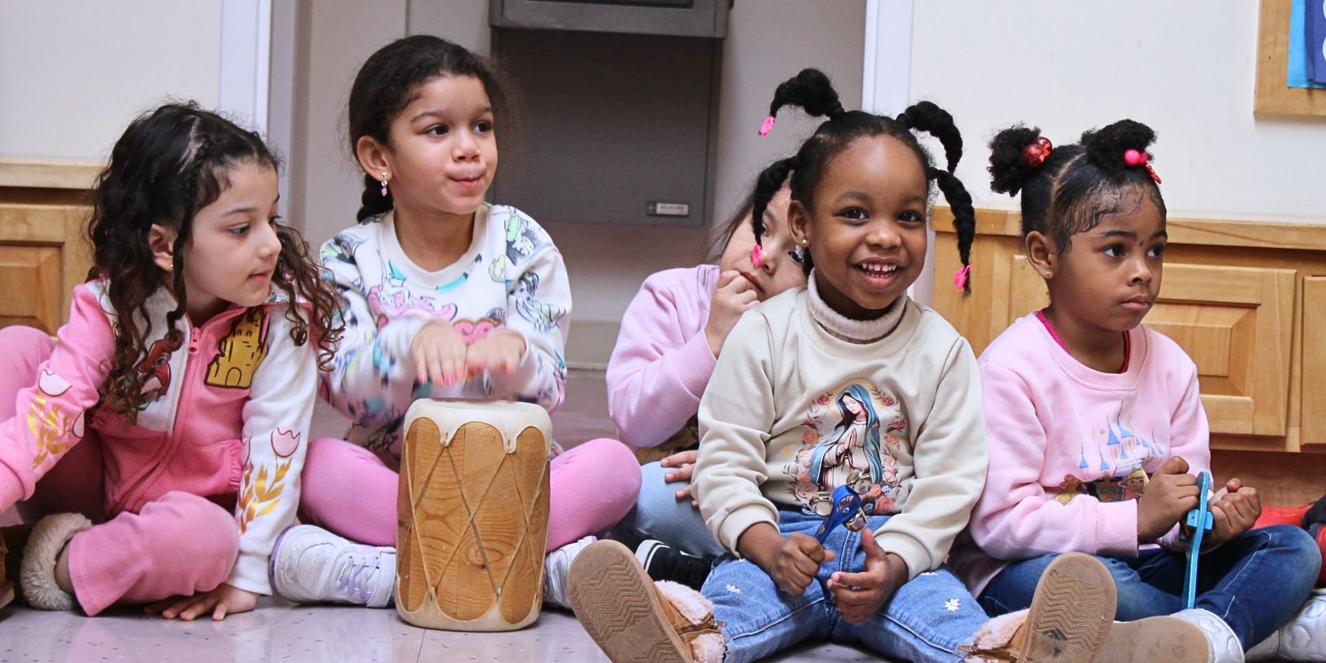 Children sitting together in a CLC classroom during a group learning activity.